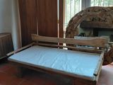 a bed that is in a room with a fireplace in the background