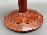 a wooden table with a wooden base and a vase on it