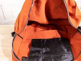 an orange bag with a black bag inside of it