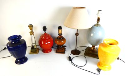 a lot of different colored vases and lamps on the table