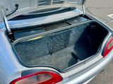le coffre d'une voiture argentée, dont le coffre est ouvert