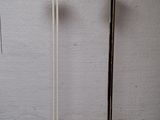 two floor lamps that are standing next to each other
