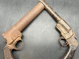 two old guns that are on a metal surface