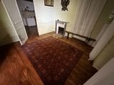 a room with a fireplace and a rug on the floor