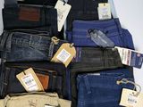 a lot of men ' s jeans on display in a store