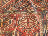 an antique persian rug with a red and blue design