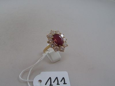 an image of a ring with a red stone surrounded by white diamonds
