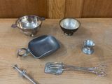 a wooden table with a variety of kitchen items on it