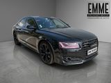 a black audi s8 saloone parked in a showroom