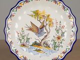 a plate with a bird on it sitting on a table