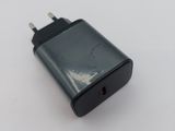 a black charger on a white surface with a white background