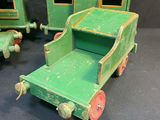 three green toy trains sitting next to each other on a table