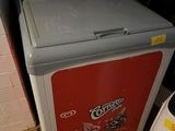 a small refrigerator that is sitting in the corner of a room