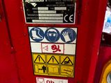 a red fire hydrant with a lot of stickers on it