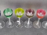 six wine glasses with different colors of wine in them on a table