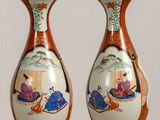 two vases that are sitting on a table