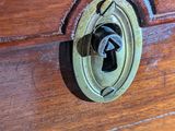 a close up of a wooden box with a lock on it