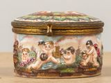 a small box with a painting on it on a table