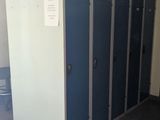 a row of blue and white stalls in a public restroom