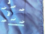 a blue pocket square with a picture of rabbits on it