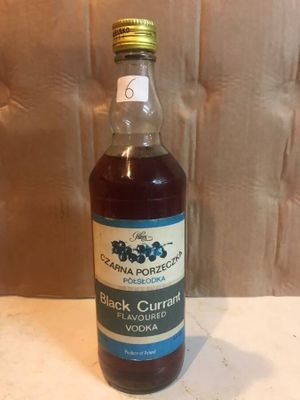 a bottle of black curran syrup sitting on a table