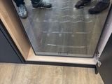 someone standing in front of a glass door with their feet on the floor
