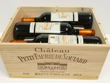 bottles of wine in a wooden box on a white surface