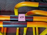 a group of yellow and black umbrellas sitting on a red bench