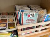 a lot of books in a wooden crate on a shelf