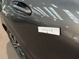 a close up of a car door handle with a sticker on it