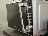 a microwave sitting on top of a shelf in a kitchen