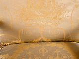 an image of a chair that has a gold and silver pattern on it