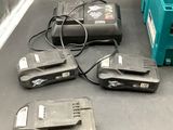 three batteries and a charger on the counter