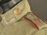 a close up of a military uniform with a button on it