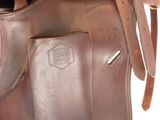 brown leather bag with a pocket on the inside of it