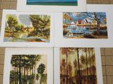 four paintings of trees and a lake on a tile floor
