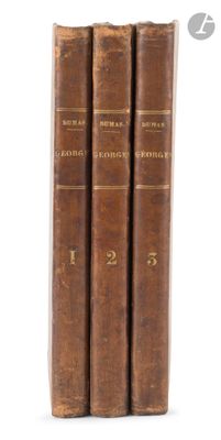 three old books are stacked on top of each other on a white surface