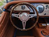 a steering wheel and dashboard of a vintage car