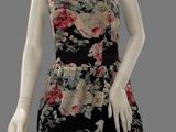 female mannequin wearing a black and pink floral print dress
