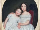 portrait de deux jeunes filles en robe blanche assises sur une chaise rouge