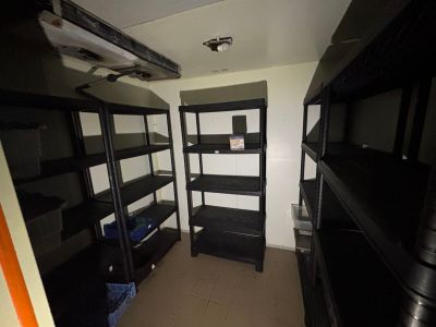 a small room with a shelf and shelves in it