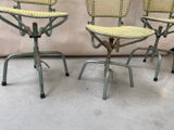 three chairs with wicker backrests are sitting on a concrete floor