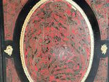a black and red cabinet with a red design on it