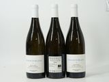 three bottles of wine sitting on top of a white table