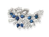 a close up of a brooch with blue and white stones