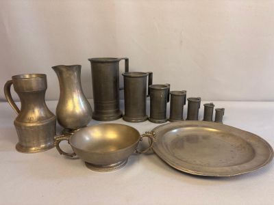 beaucoup d'objets en étain posés sur une table blanche