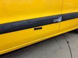 a yellow car with a black stripe on the side of it