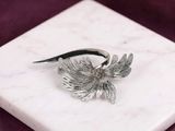 sterling silver plated bird ring on a white marble block