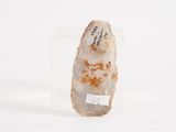 a rock with writing on it sitting on a white surface