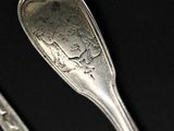 two spoons that are sitting on a table